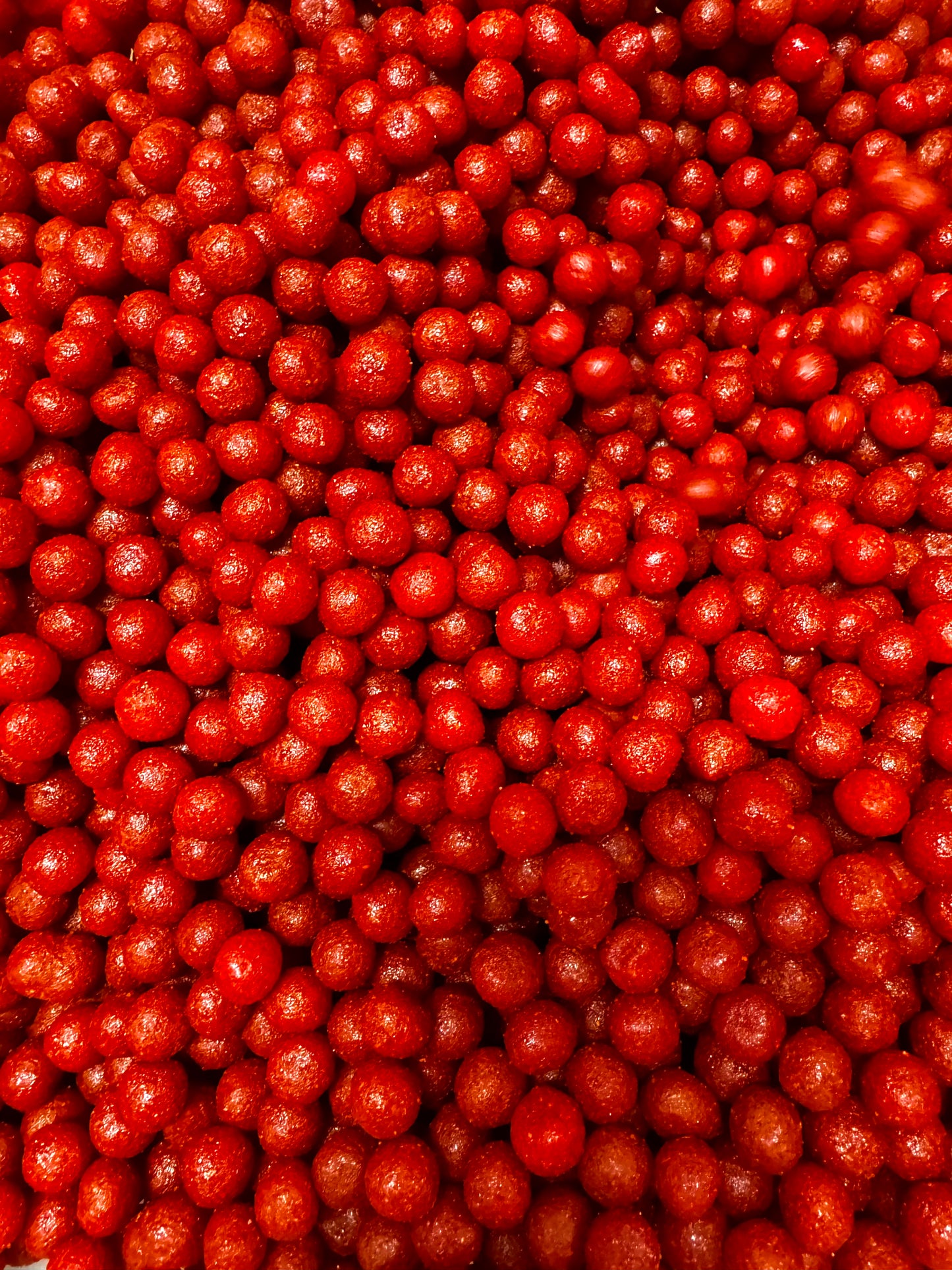 close up of cherry candy covered with a layer of chamoy and chili 