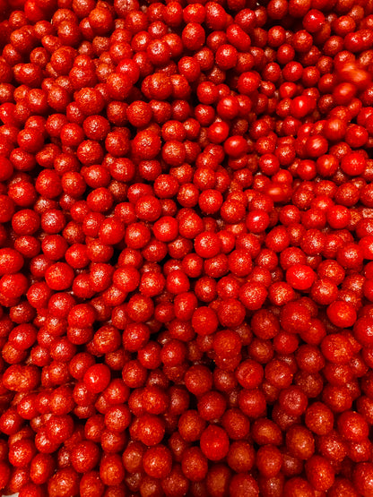 close up of cherry candy covered with a layer of chamoy and chili 