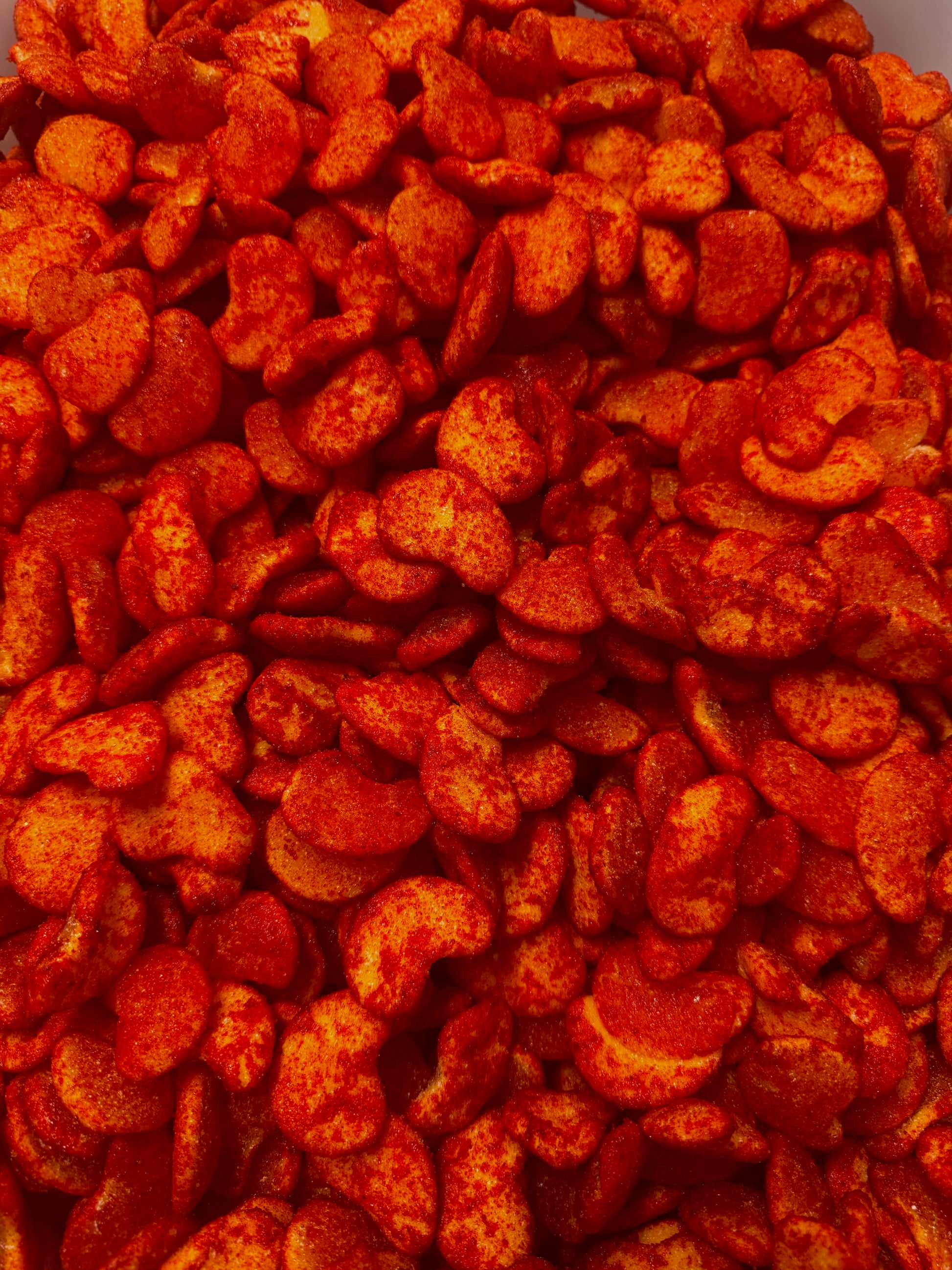 Close up of gummies shape up as mangoes covered in chamoy and chili 