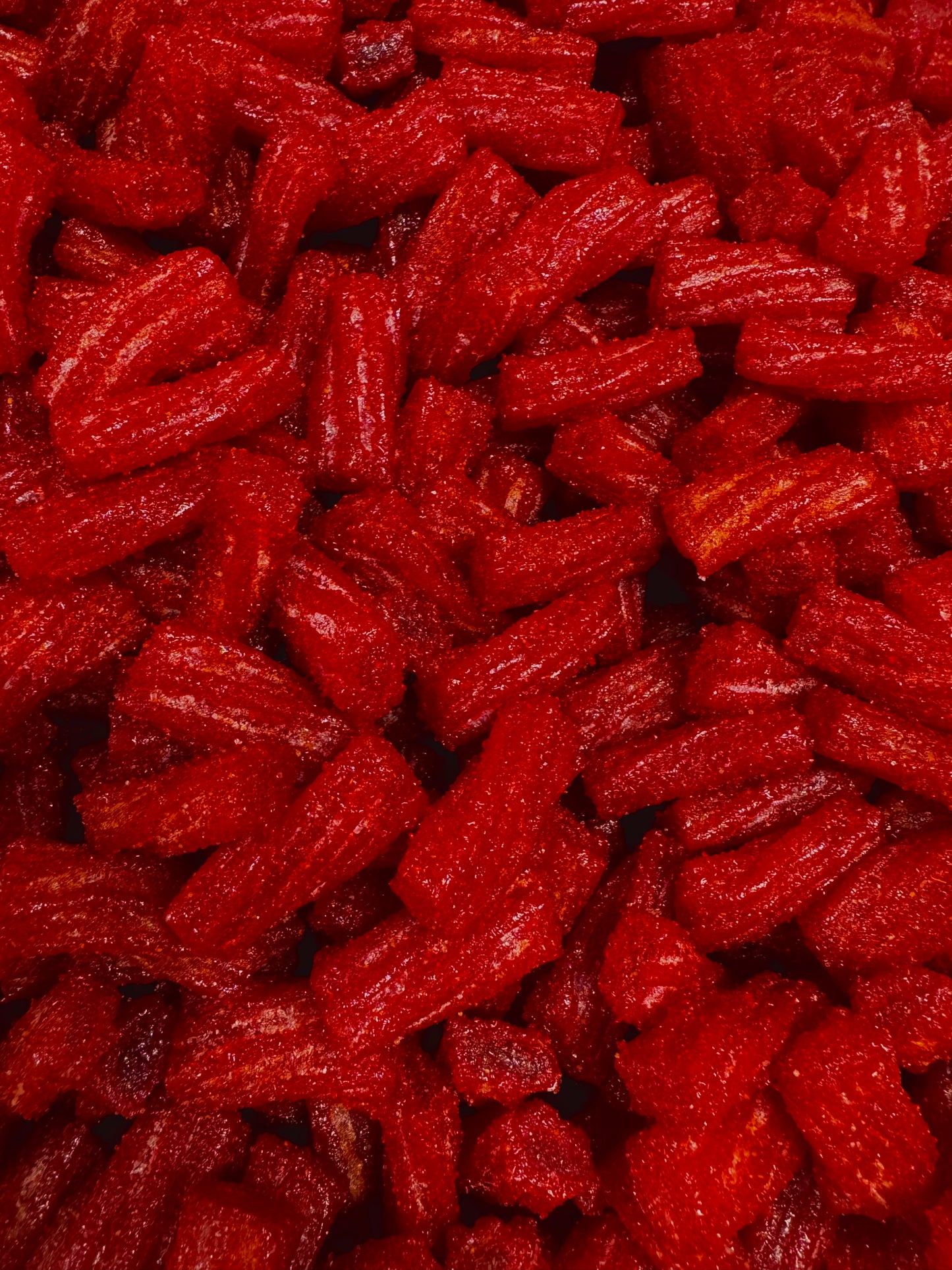close up of red licorice candy cover in chamoy and chili 